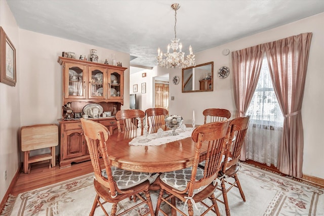 dining room featuring a chandelier and light wood-type flooring