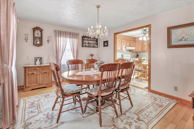 dining room with an inviting chandelier and light hardwood / wood-style flooring