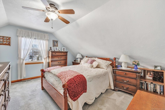 bedroom with light carpet, vaulted ceiling, and ceiling fan