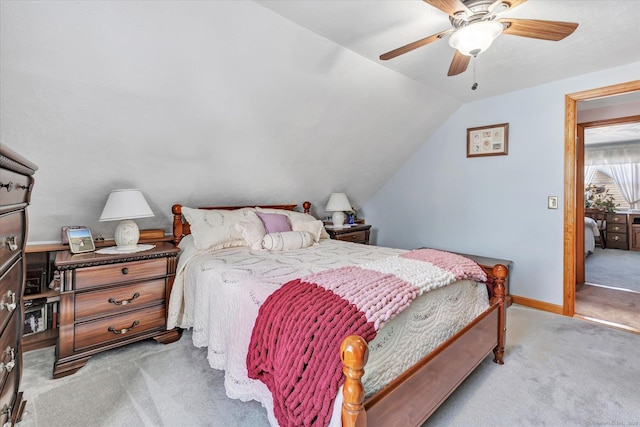 bedroom with vaulted ceiling, light carpet, and ceiling fan