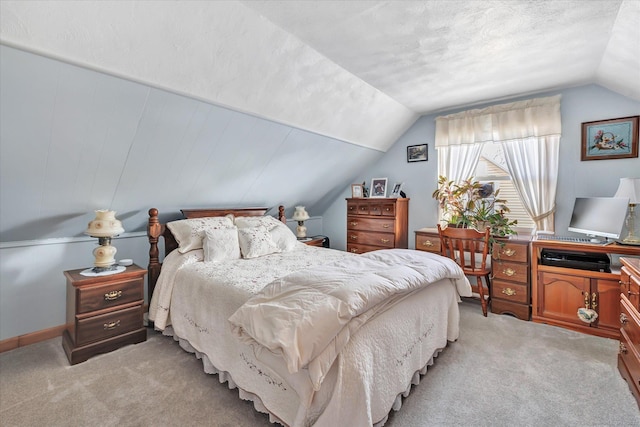 bedroom with lofted ceiling and light colored carpet