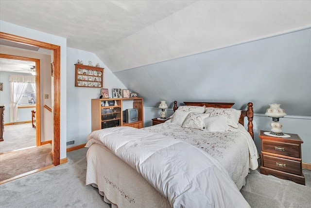 carpeted bedroom with lofted ceiling