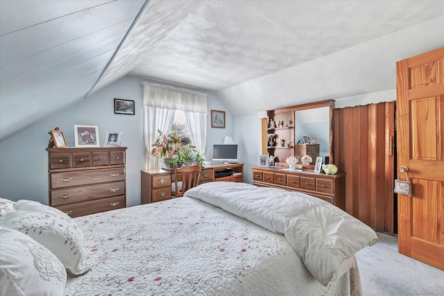 carpeted bedroom featuring vaulted ceiling