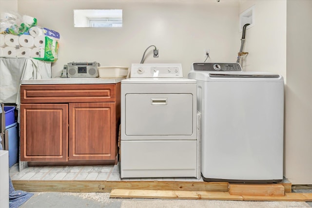 laundry area featuring cabinets and washer and clothes dryer