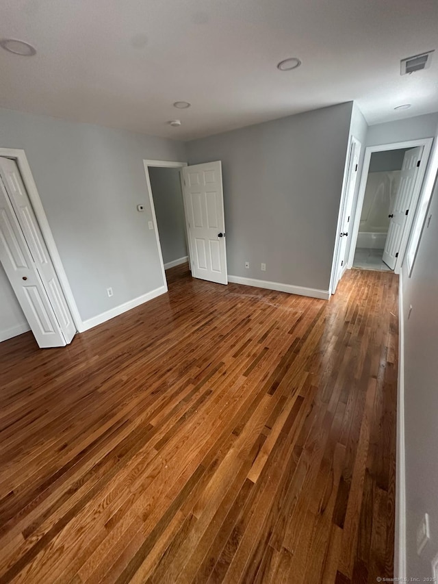 empty room with dark hardwood / wood-style flooring