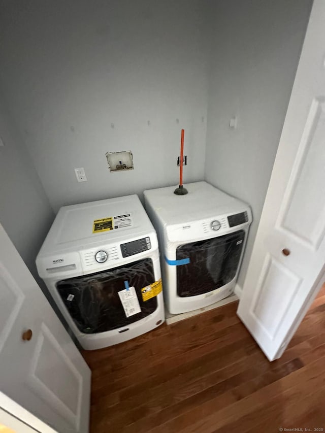 laundry area featuring washer and clothes dryer and dark hardwood / wood-style floors