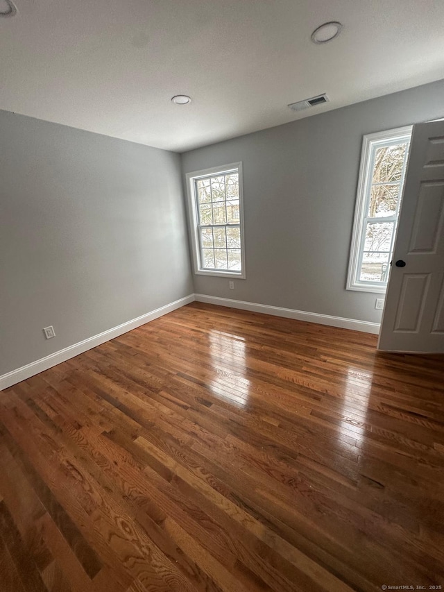 unfurnished room with dark hardwood / wood-style floors