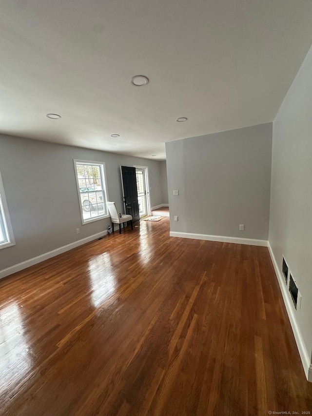 unfurnished room with dark hardwood / wood-style floors