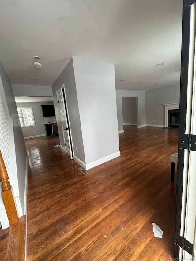 corridor with dark wood-type flooring