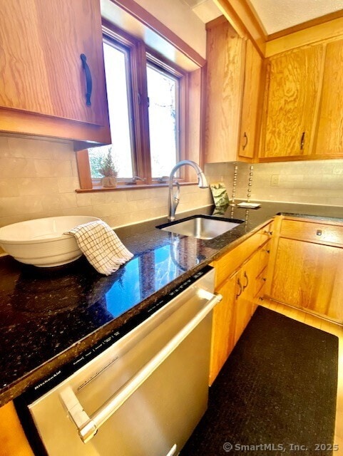 kitchen with sink, dishwasher, and tasteful backsplash