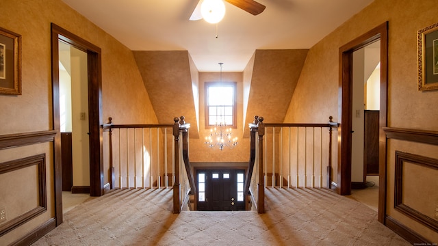 unfurnished dining area featuring light colored carpet and a chandelier