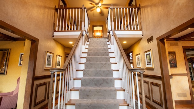 stairs featuring a towering ceiling