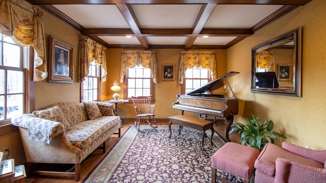 living area with coffered ceiling, hardwood / wood-style flooring, and beamed ceiling