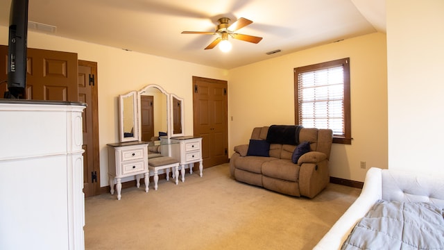 bedroom featuring light colored carpet and ceiling fan