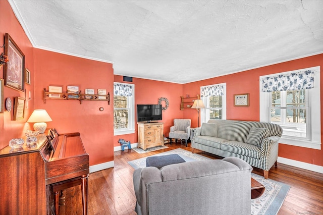 living room featuring crown molding, wood-type flooring, and a textured ceiling