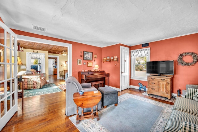 living room with hardwood / wood-style floors, a textured ceiling, and a wealth of natural light