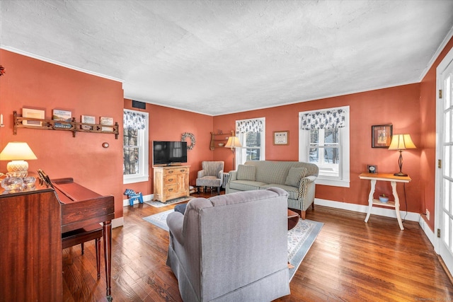 living room featuring hardwood / wood-style flooring, crown molding, and a textured ceiling