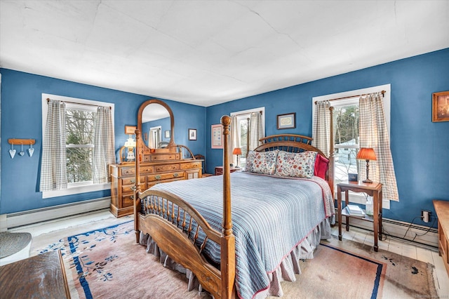 bedroom featuring baseboard heating and light hardwood / wood-style floors