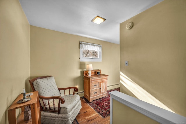 living area with a baseboard radiator and wood-type flooring