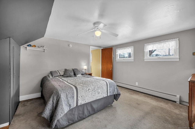 carpeted bedroom featuring ceiling fan, vaulted ceiling, and a baseboard heating unit