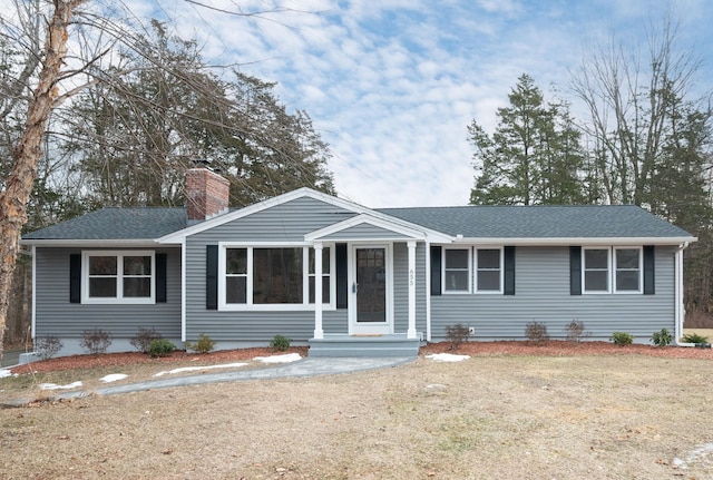 ranch-style home with a front lawn