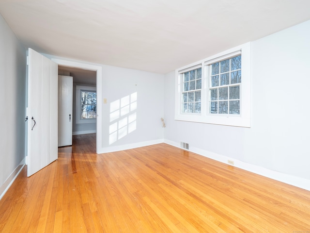 unfurnished room featuring light hardwood / wood-style floors