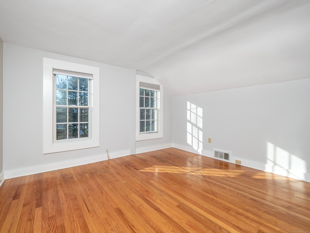 interior space with vaulted ceiling and light hardwood / wood-style floors