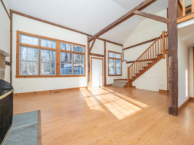 living room with beam ceiling, high vaulted ceiling, and light hardwood / wood-style floors