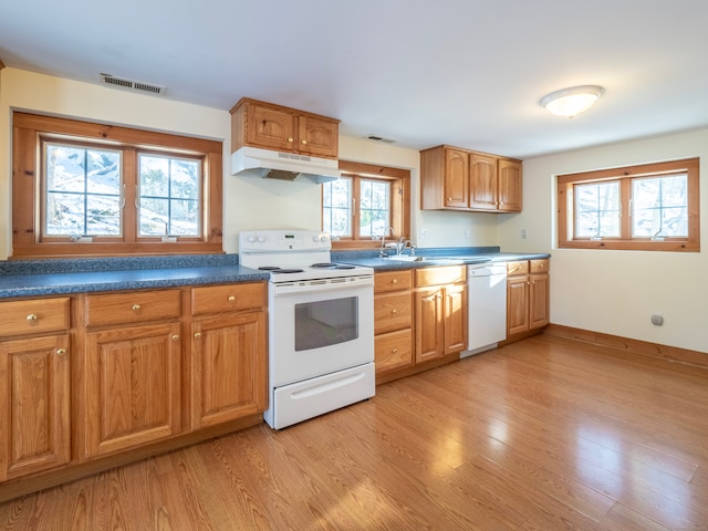 kitchen featuring white appliances, sink, and light hardwood / wood-style flooring