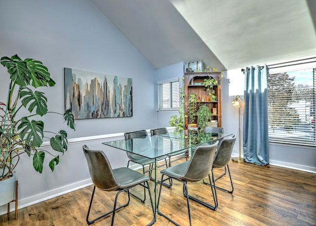 dining area with wood-type flooring and lofted ceiling