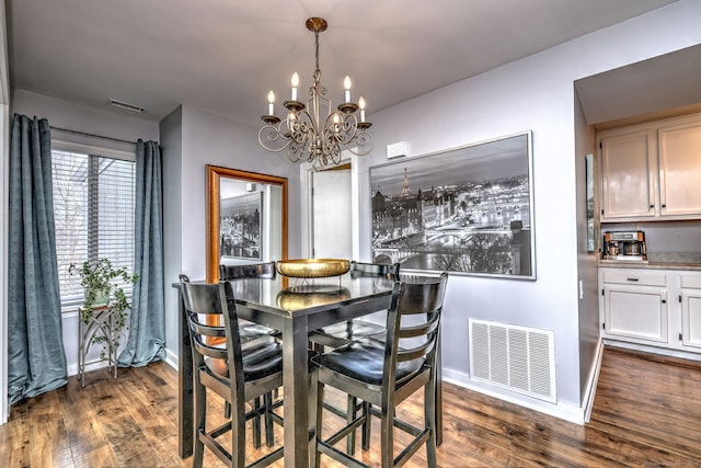 dining room featuring dark hardwood / wood-style flooring and a chandelier