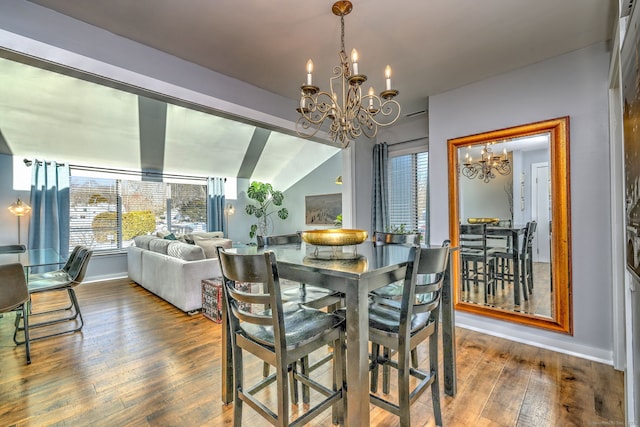 dining area with hardwood / wood-style floors and a notable chandelier