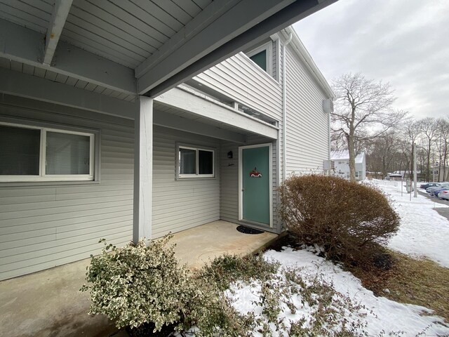 view of snow covered property entrance