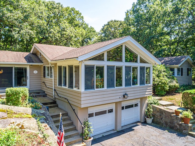 view of front of house with a garage and a sunroom