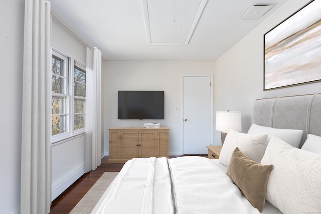 bedroom with dark hardwood / wood-style floors