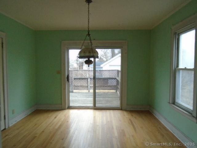 unfurnished dining area featuring light hardwood / wood-style flooring and plenty of natural light