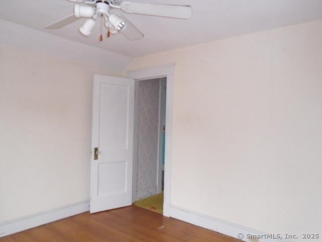 spare room with hardwood / wood-style floors and ceiling fan