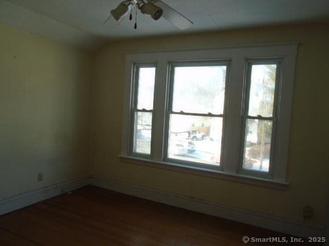 spare room featuring ceiling fan, wood-type flooring, and lofted ceiling