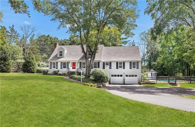 view of front of home featuring a garage and a front lawn