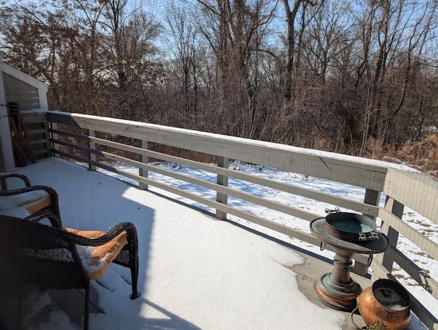 view of snow covered back of property