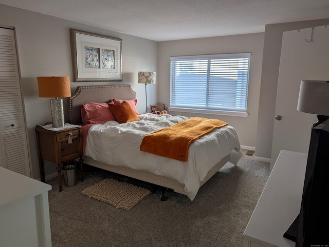 carpeted bedroom featuring a closet and a textured ceiling