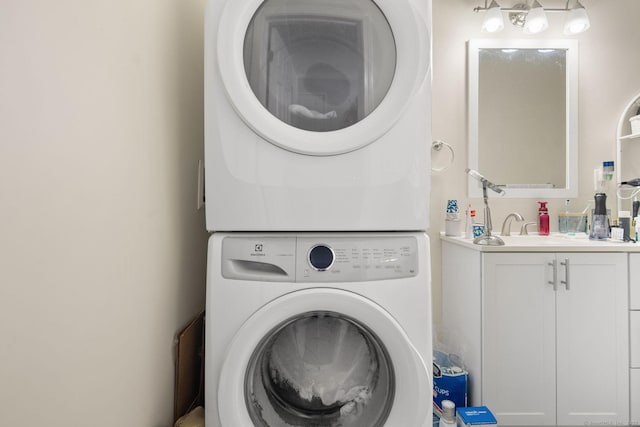 laundry area with stacked washer / drying machine