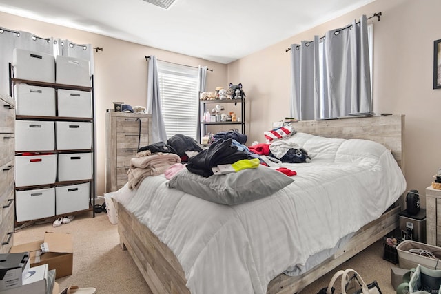 bedroom featuring light carpet