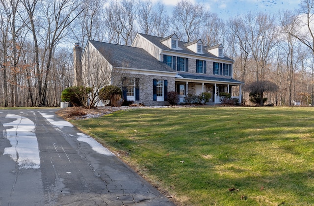 cape cod-style house featuring a porch and a front lawn