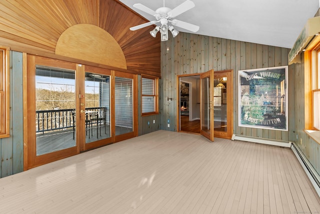 unfurnished sunroom with ceiling fan, wooden ceiling, vaulted ceiling, and a baseboard heating unit