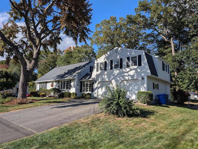 view of front of property with a garage and a front yard