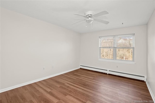 empty room with hardwood / wood-style flooring, a baseboard radiator, and ceiling fan