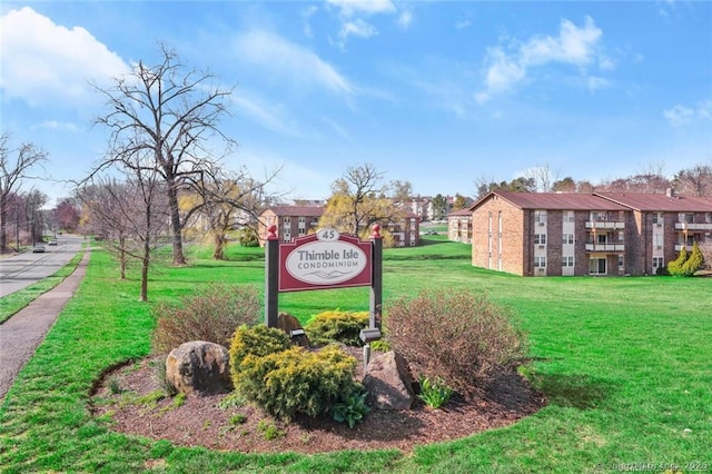 community / neighborhood sign featuring a lawn