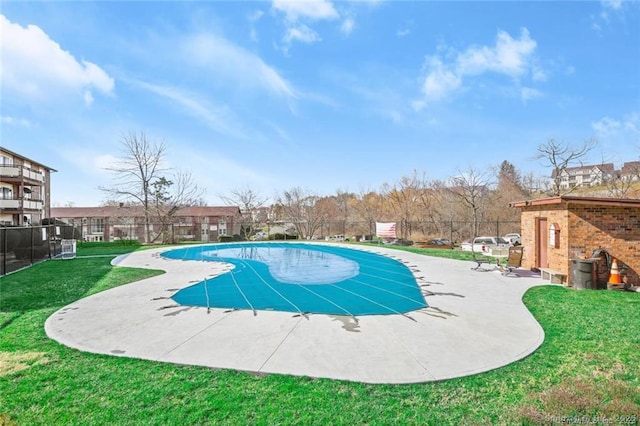 view of swimming pool with a patio area and a lawn