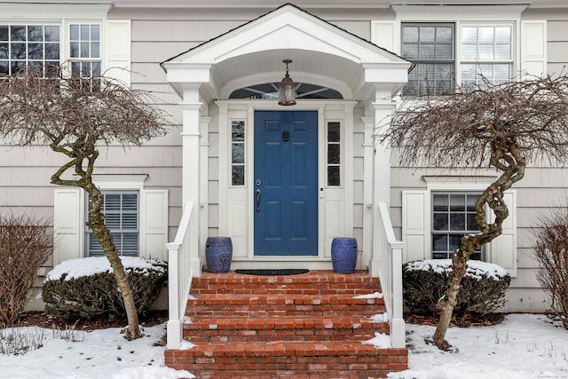 view of snow covered property entrance